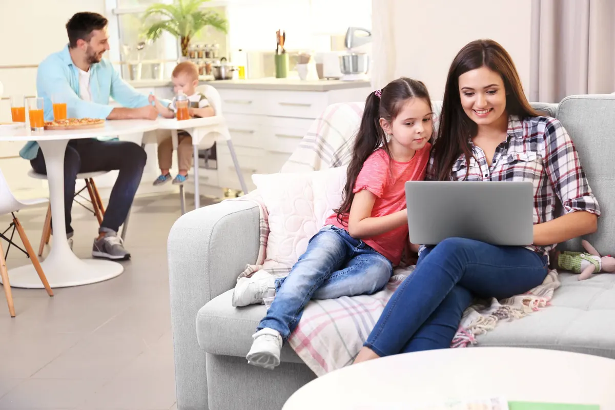 Family using technology in a comfortable indoor environment